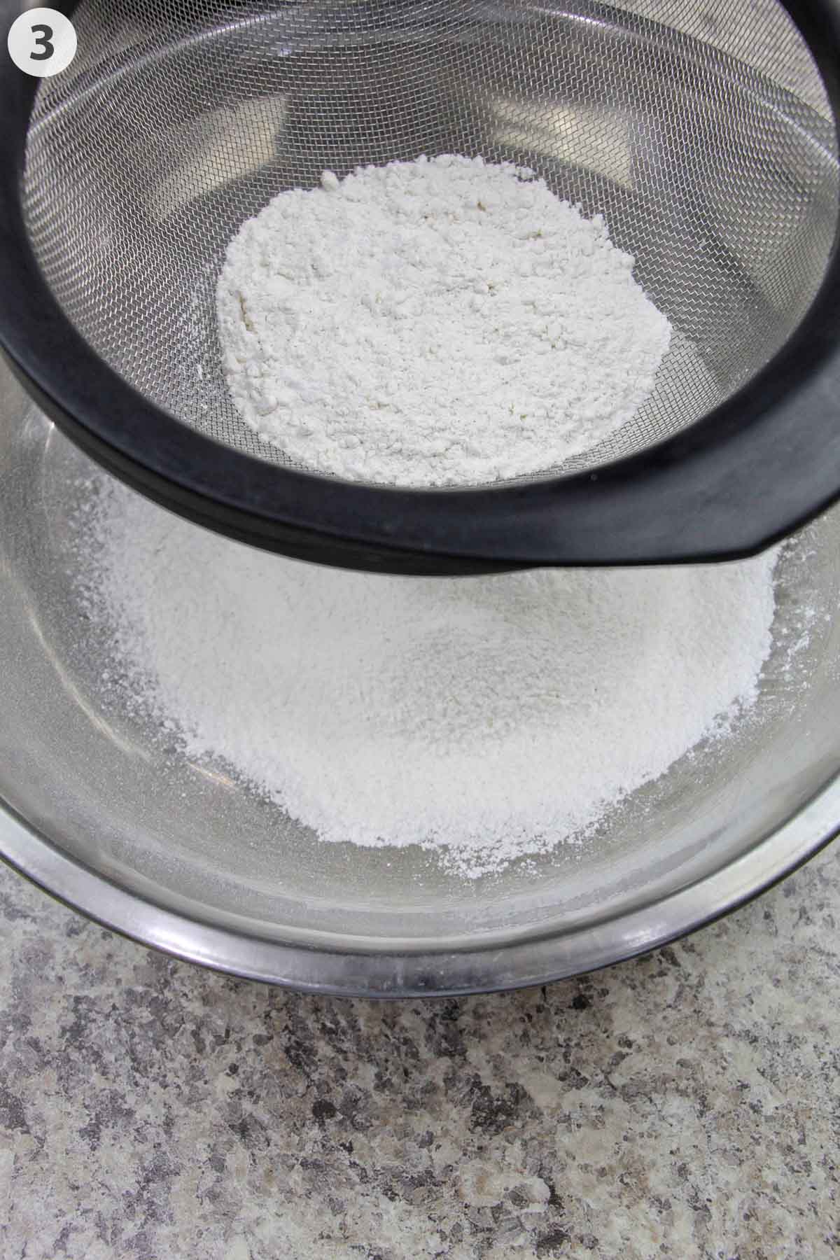number photo showing sifting flour into a mixing bowl.