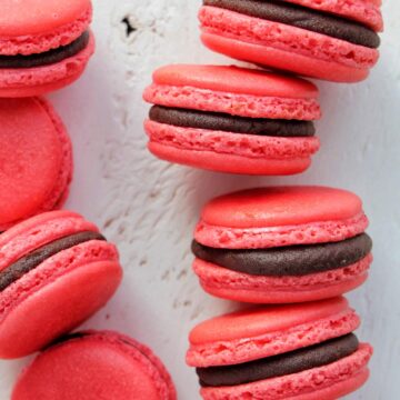 red macarons filled with raspberry chocolate ganache.