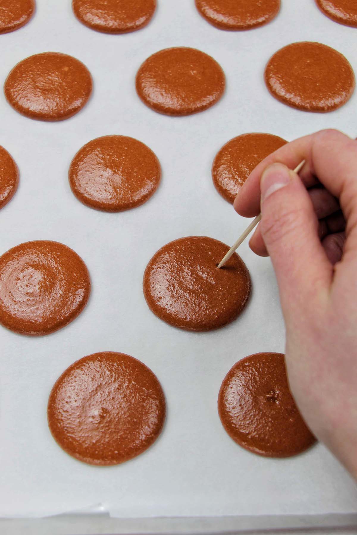 popping air bubbles with a toothpick.