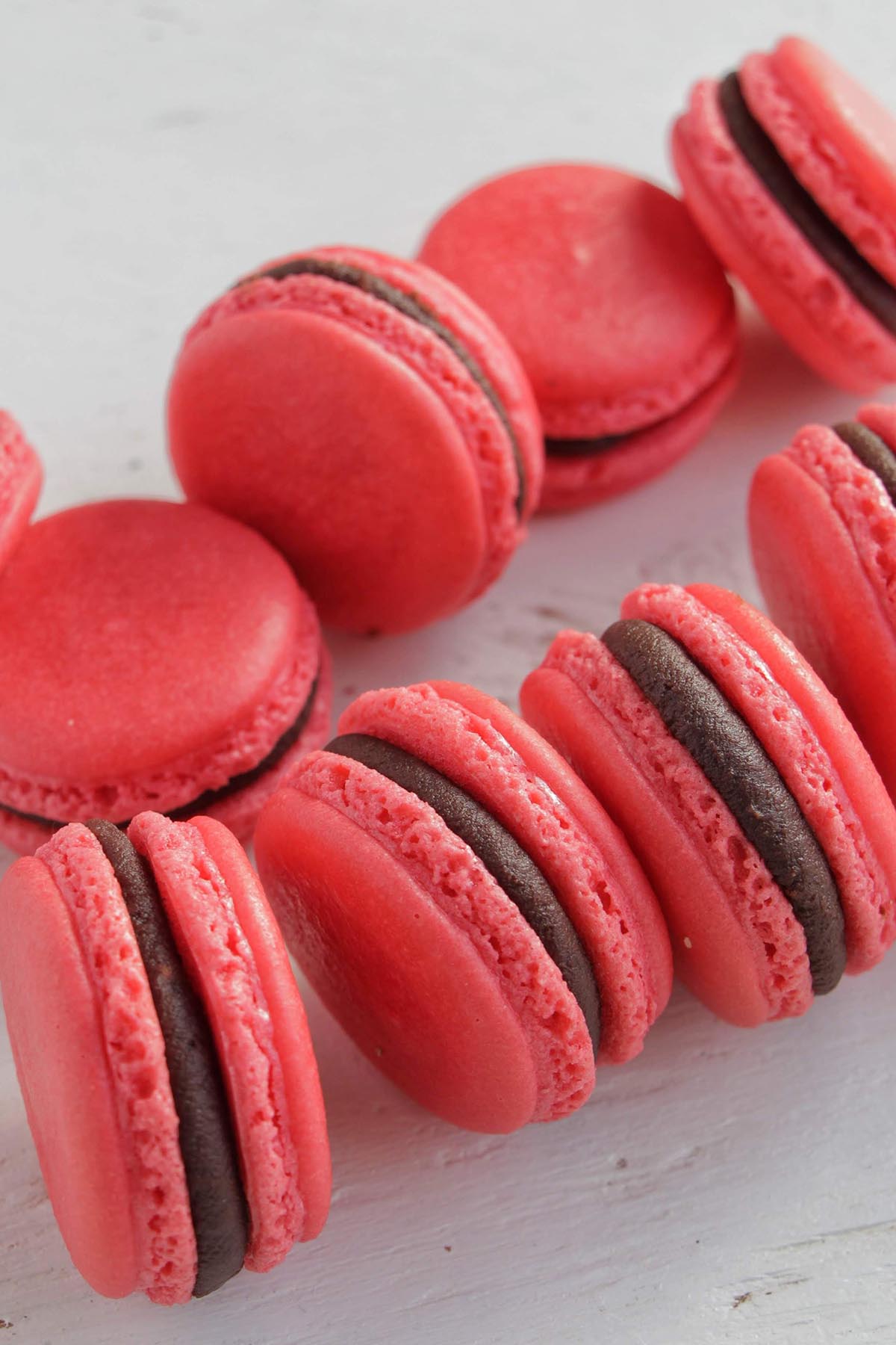 red macarons filled with raspberry chocolate ganache.