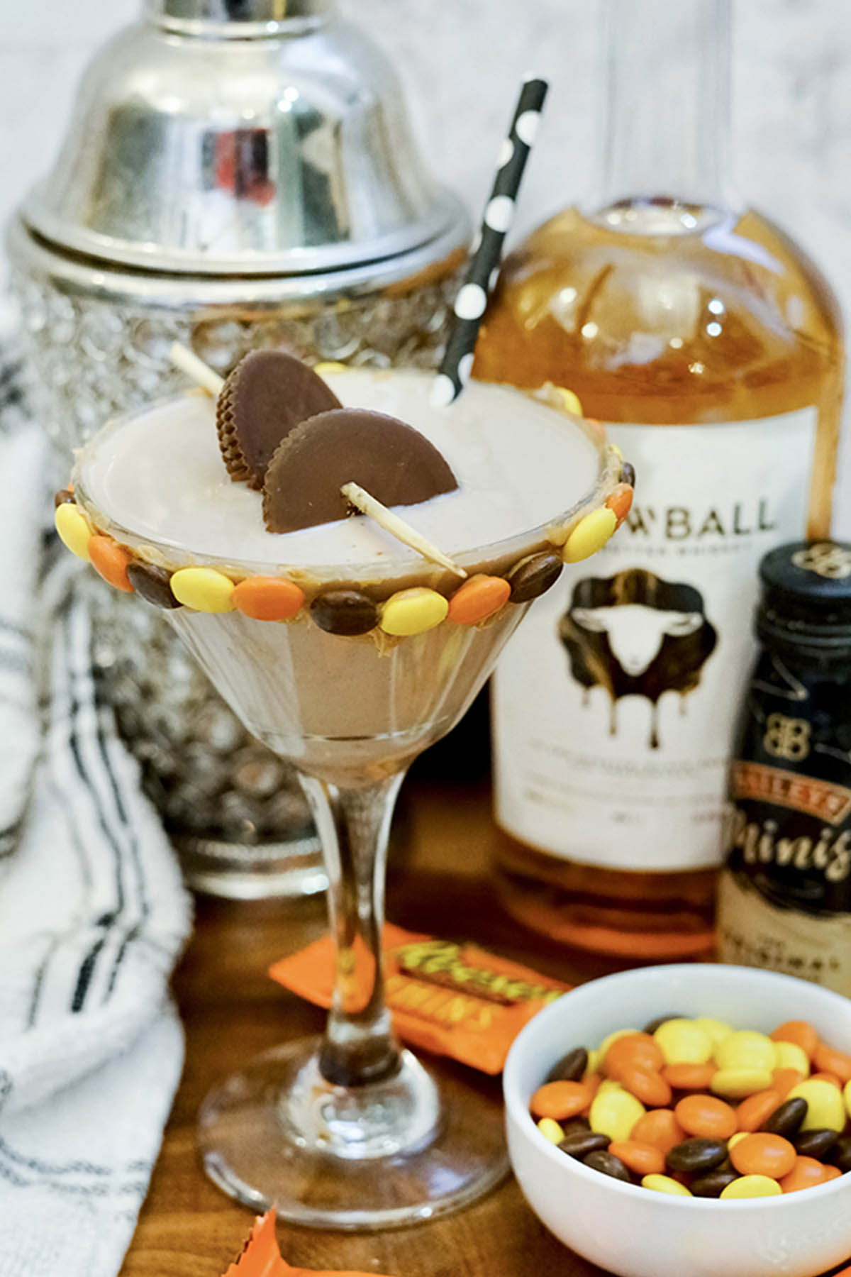 peanut butter whiskey martini garnished with candy.
