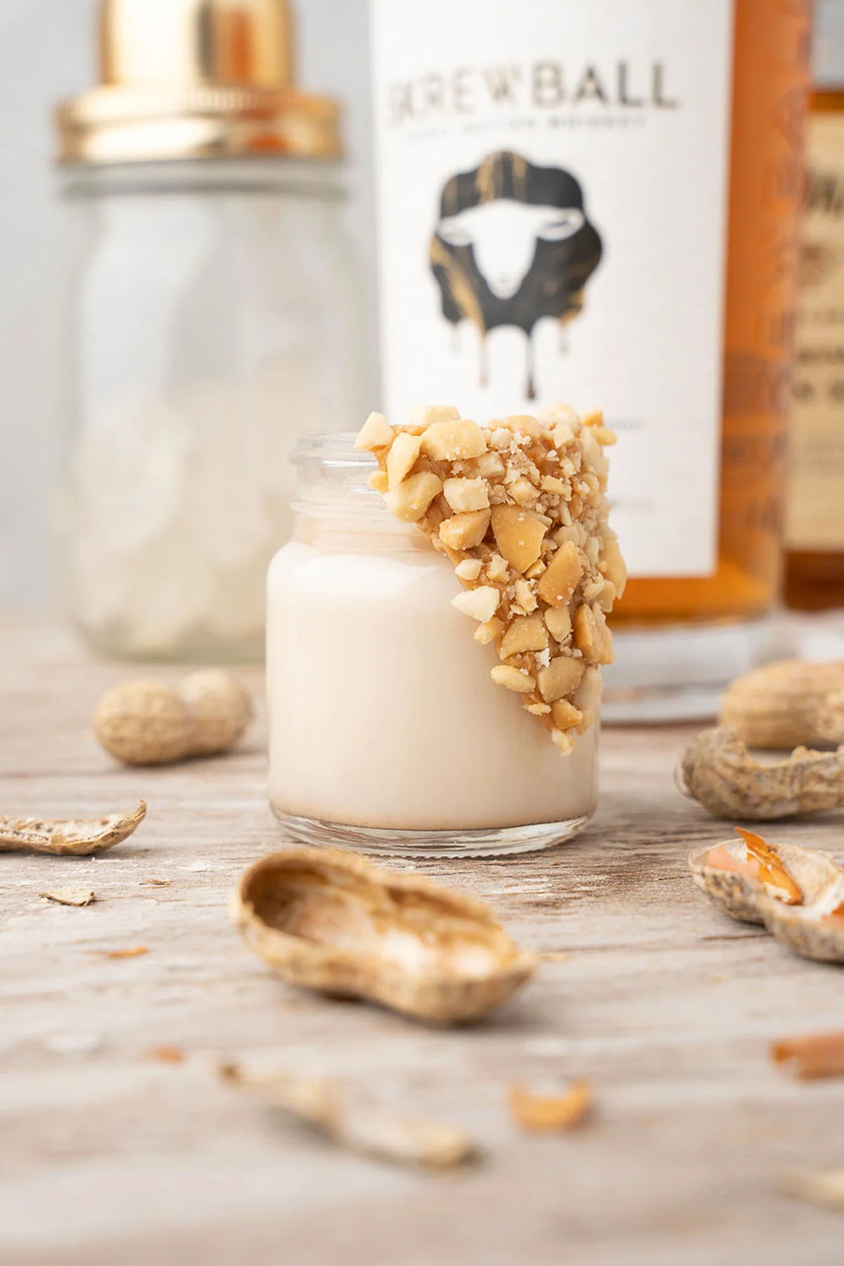 honey peanut butter whiskey shot garnished with peanuts.