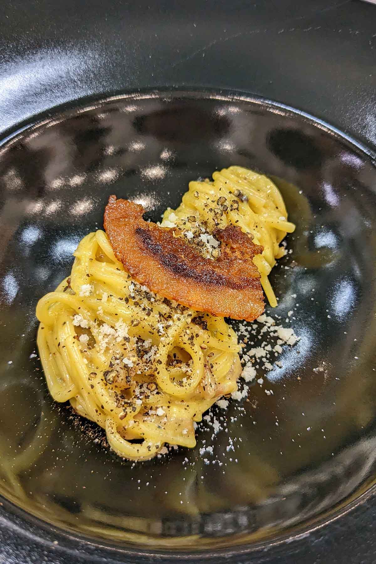 carbonara garnished with guanciale.