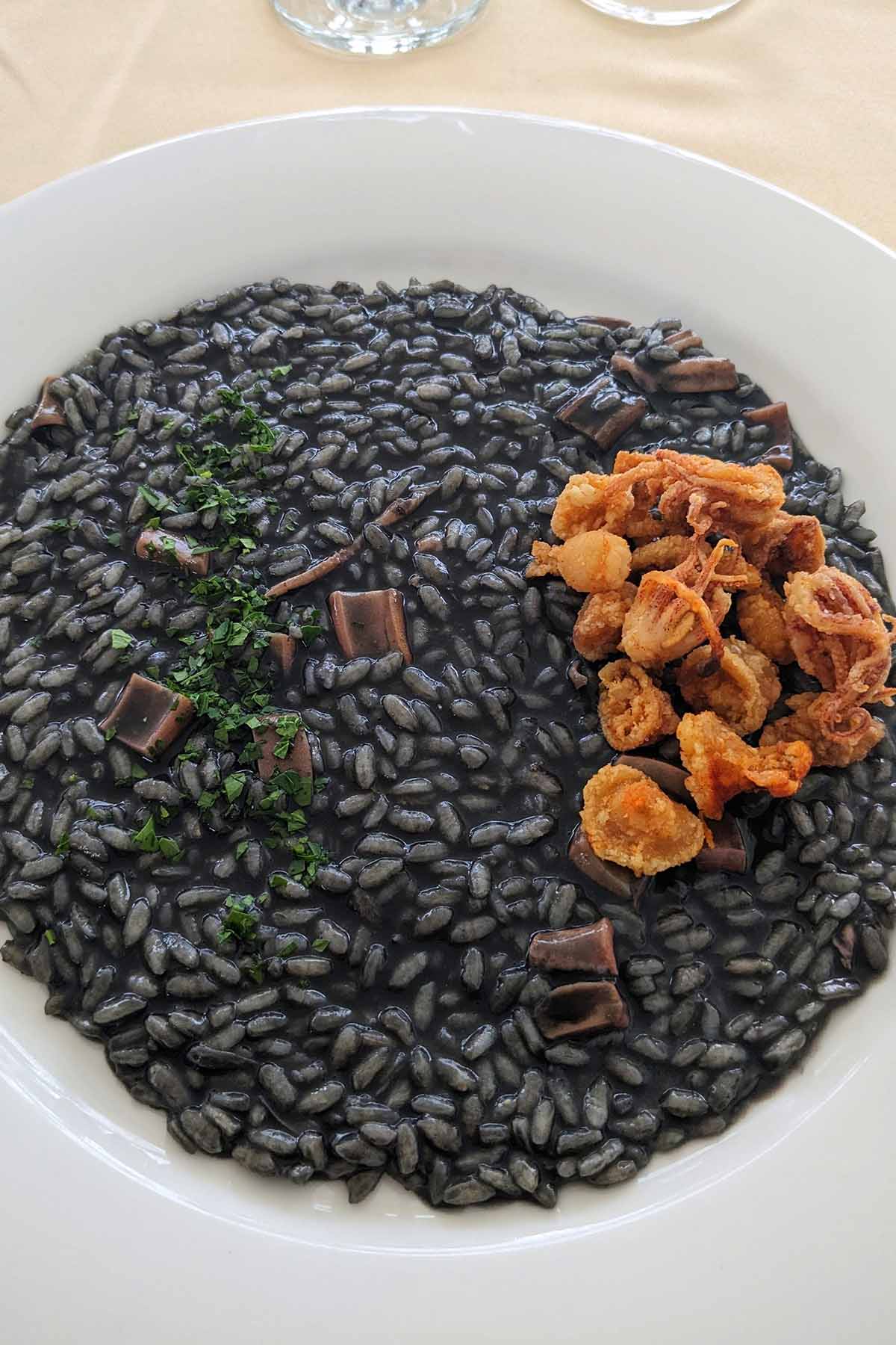 black risotto topped with fired mini squid.