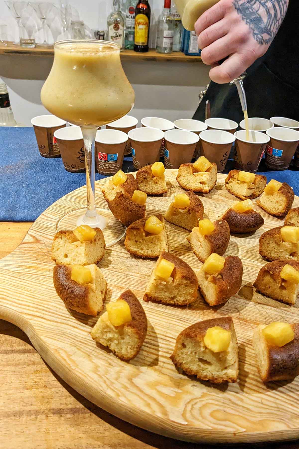 tray of dessert tastings next to a cocktail.