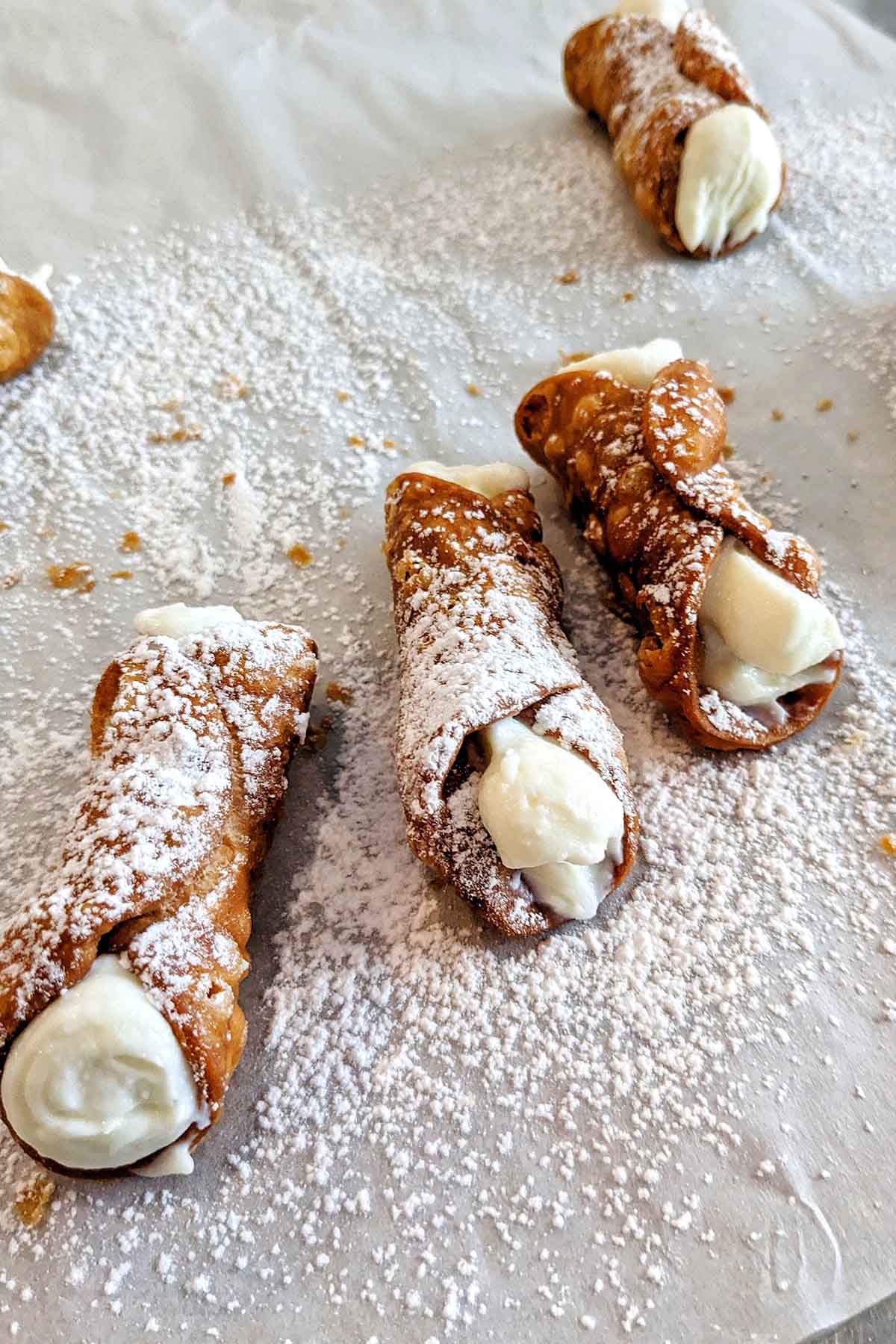 cannoli sprinkled with powdered sugar.