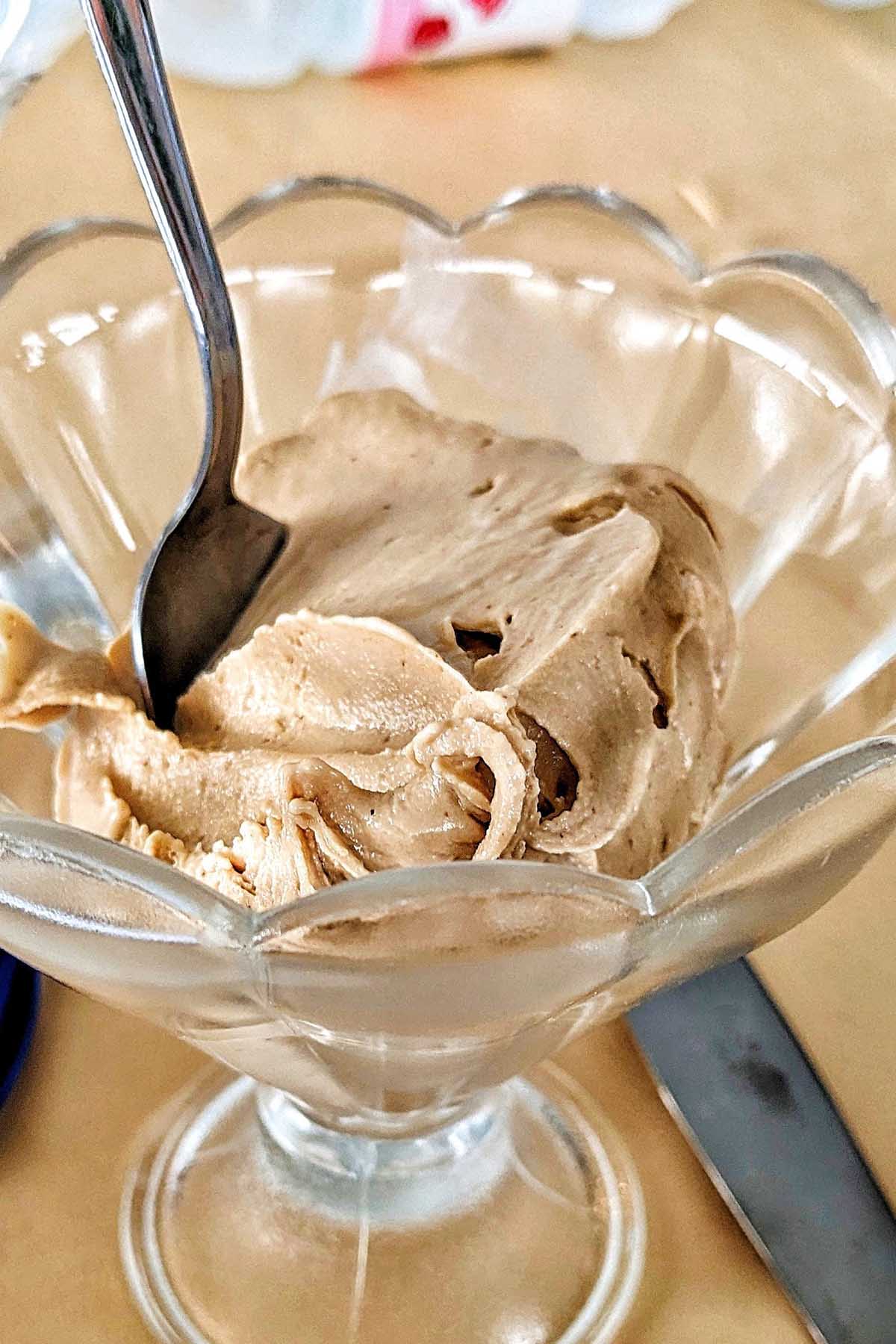 hazelnut gelato in a glass bowl.