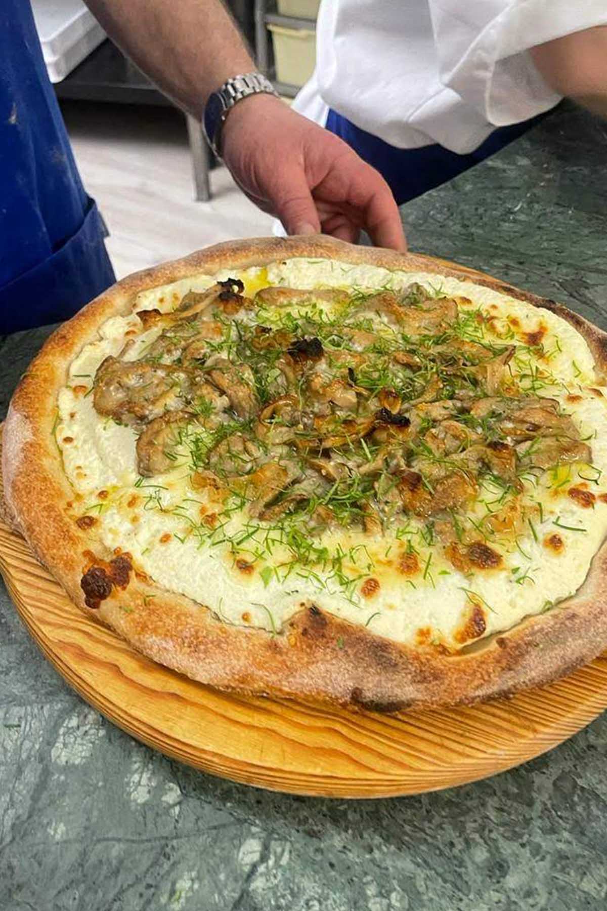 ricotta mushroom pizza on a tray.