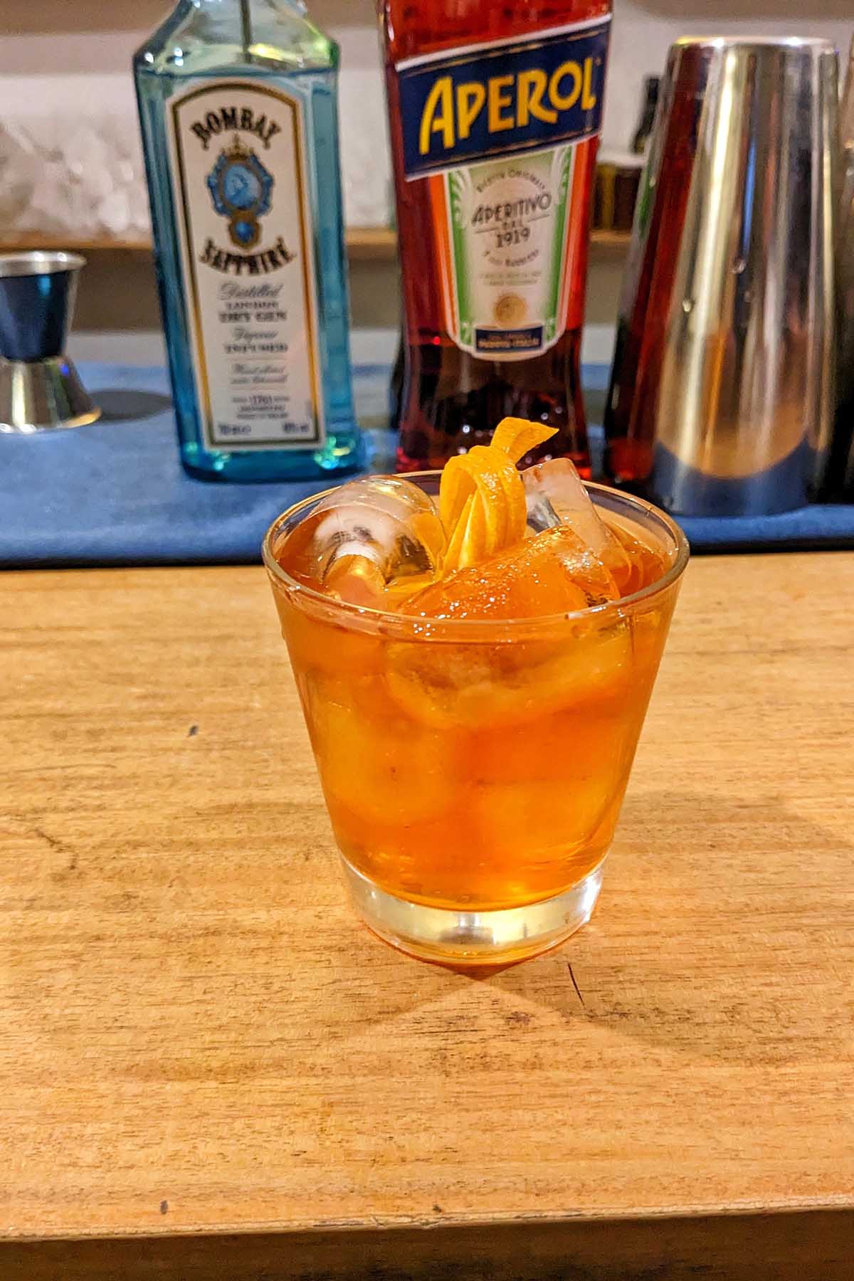 negroni cocktail with orange garnish.