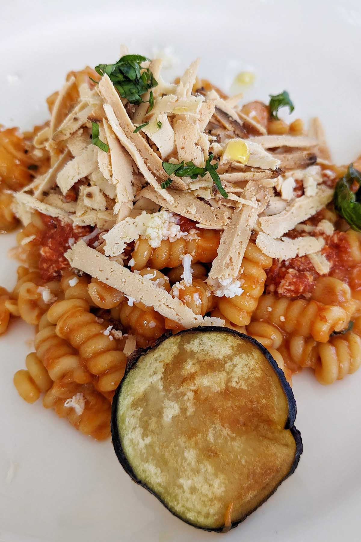 pasta alla Norma garnished with ricotta salata.