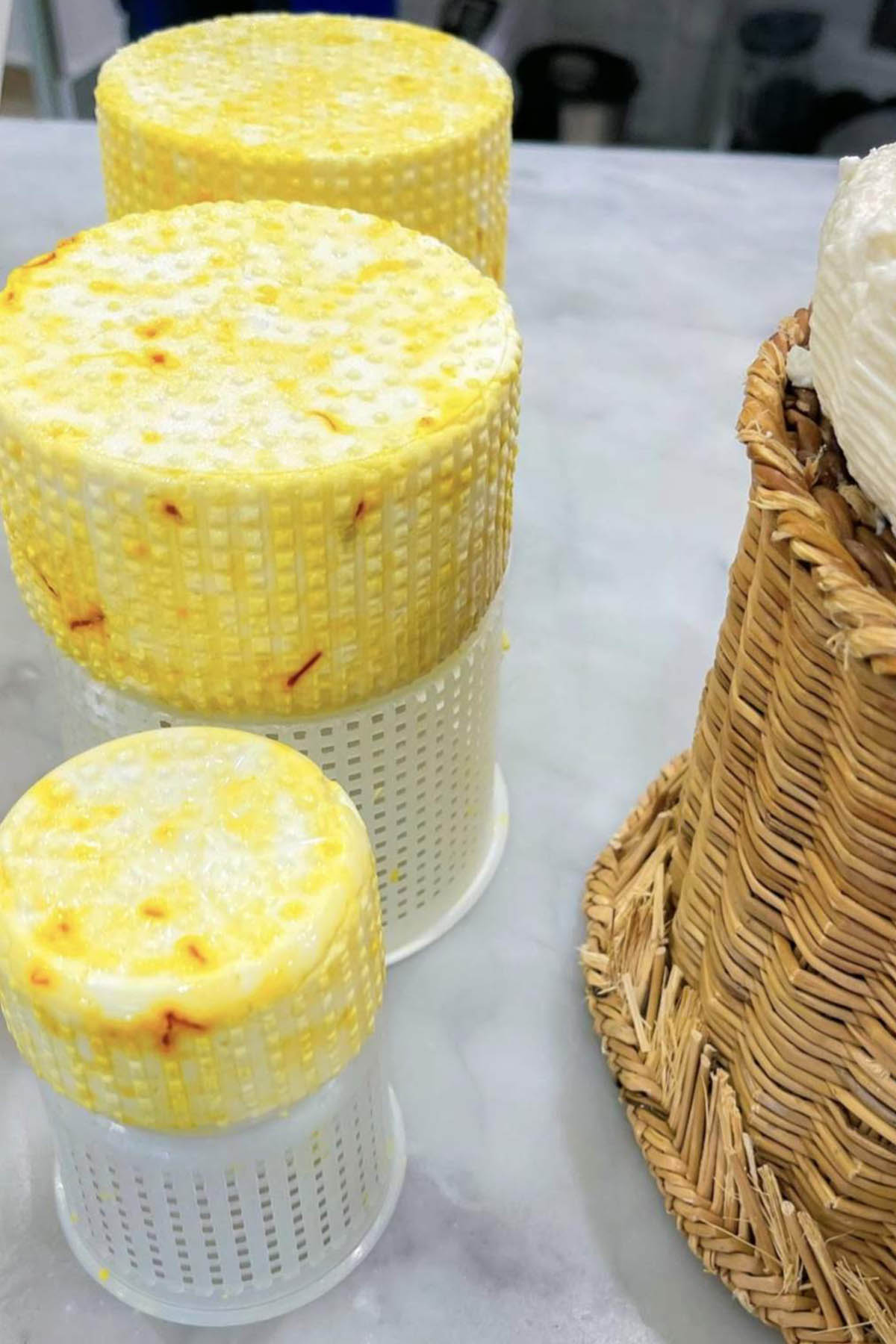 three blocks of saffron pecorino cheese.