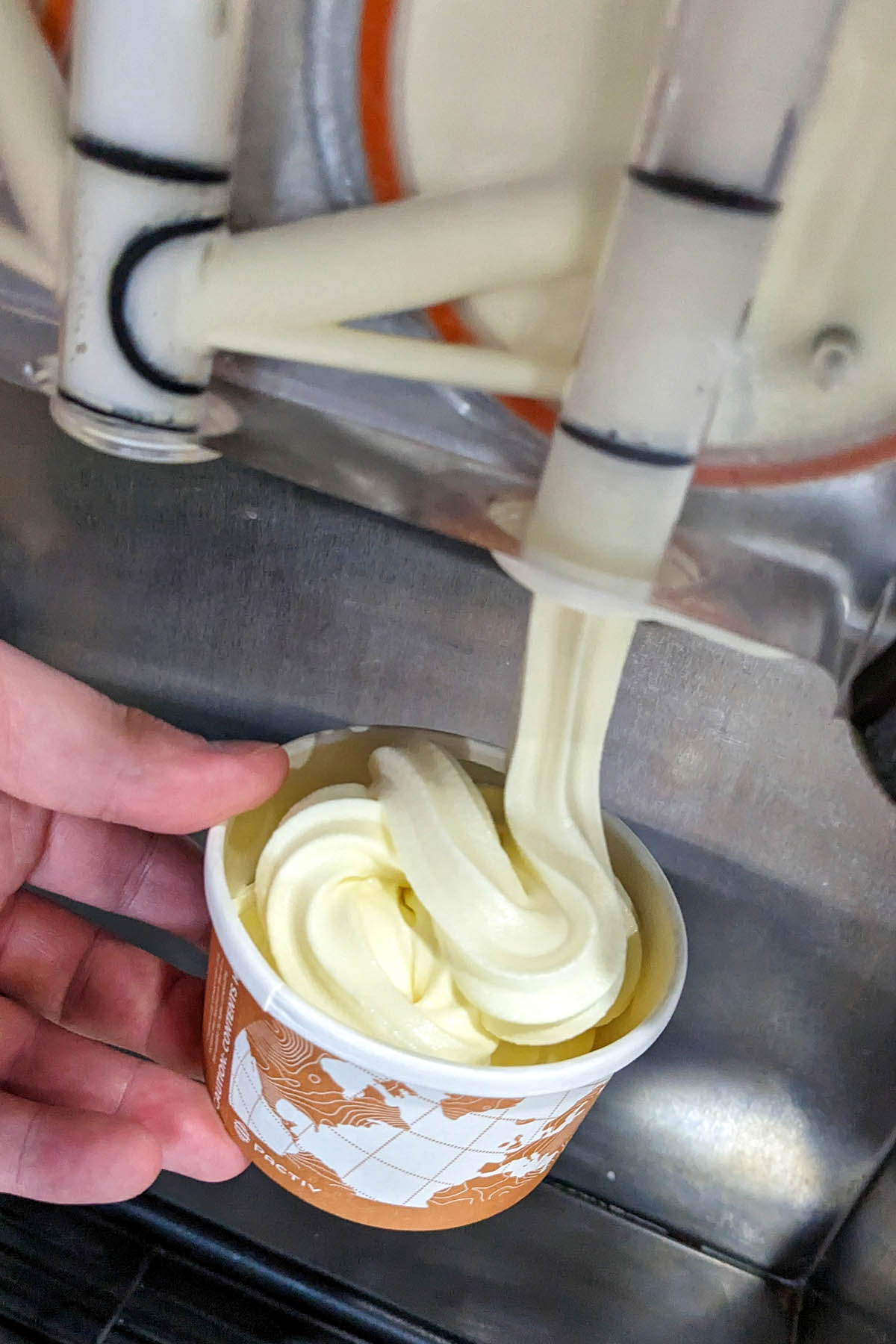vanilla soft serve ice cream coming out of a machine.