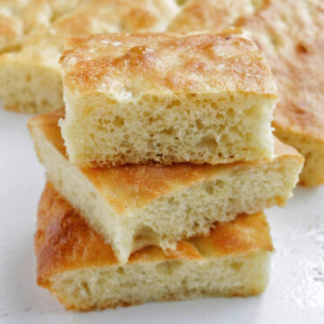 three pieces of focaccia bread stacked on top of each other.