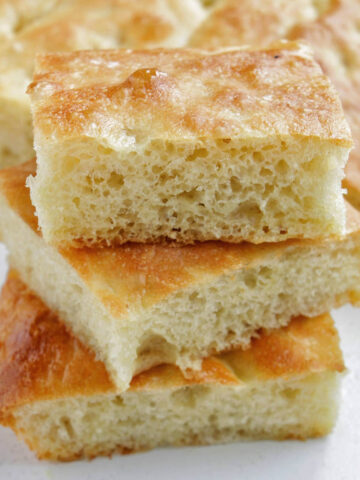three pieces of focaccia bread stacked on top of each other.