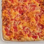 cheese focaccia in a sheet pan.
