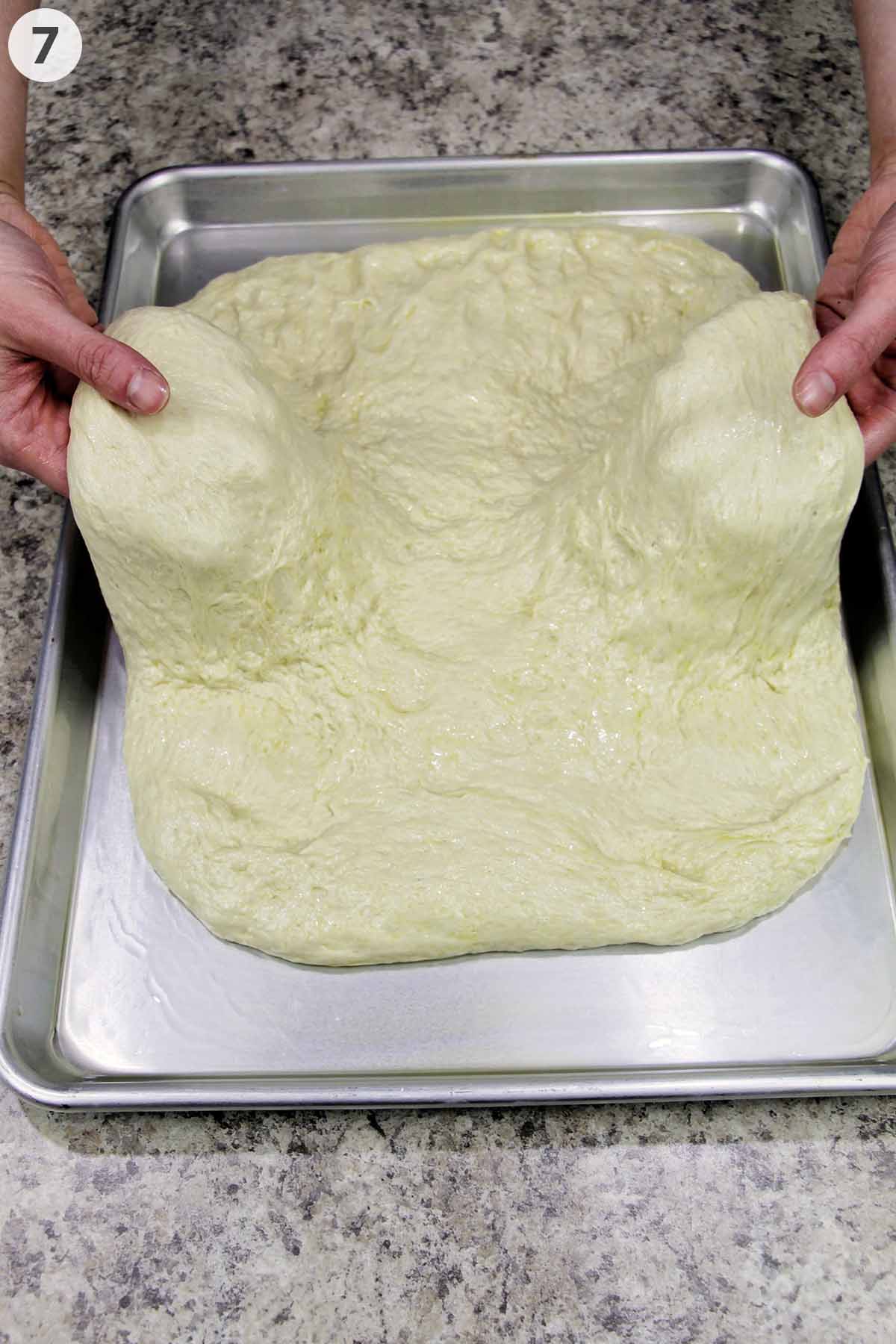 numbered photo stretching out focaccia dough on a sheet pan.