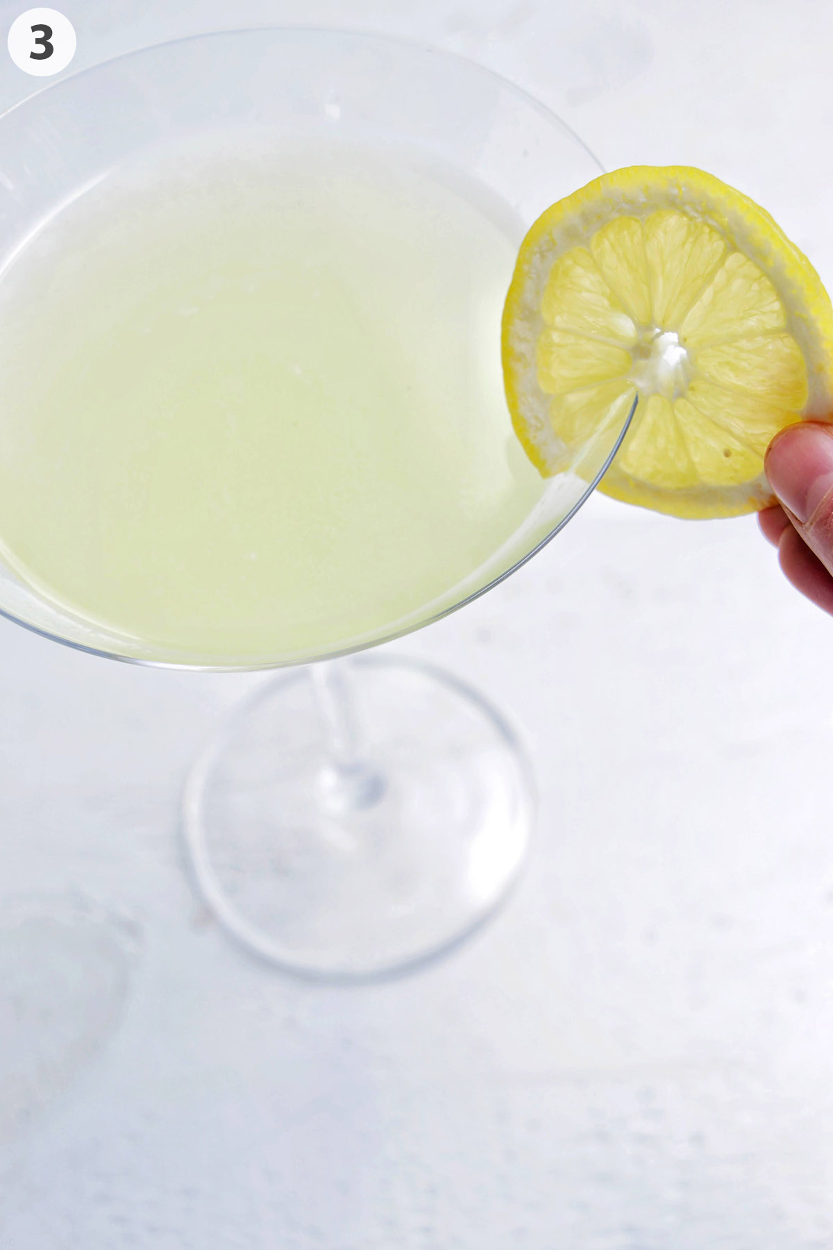 numbered photo garnishing a lemon drop martini with a lemon wheel.
