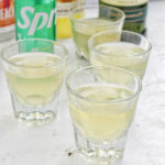 four green tea shots in rocks glasses.