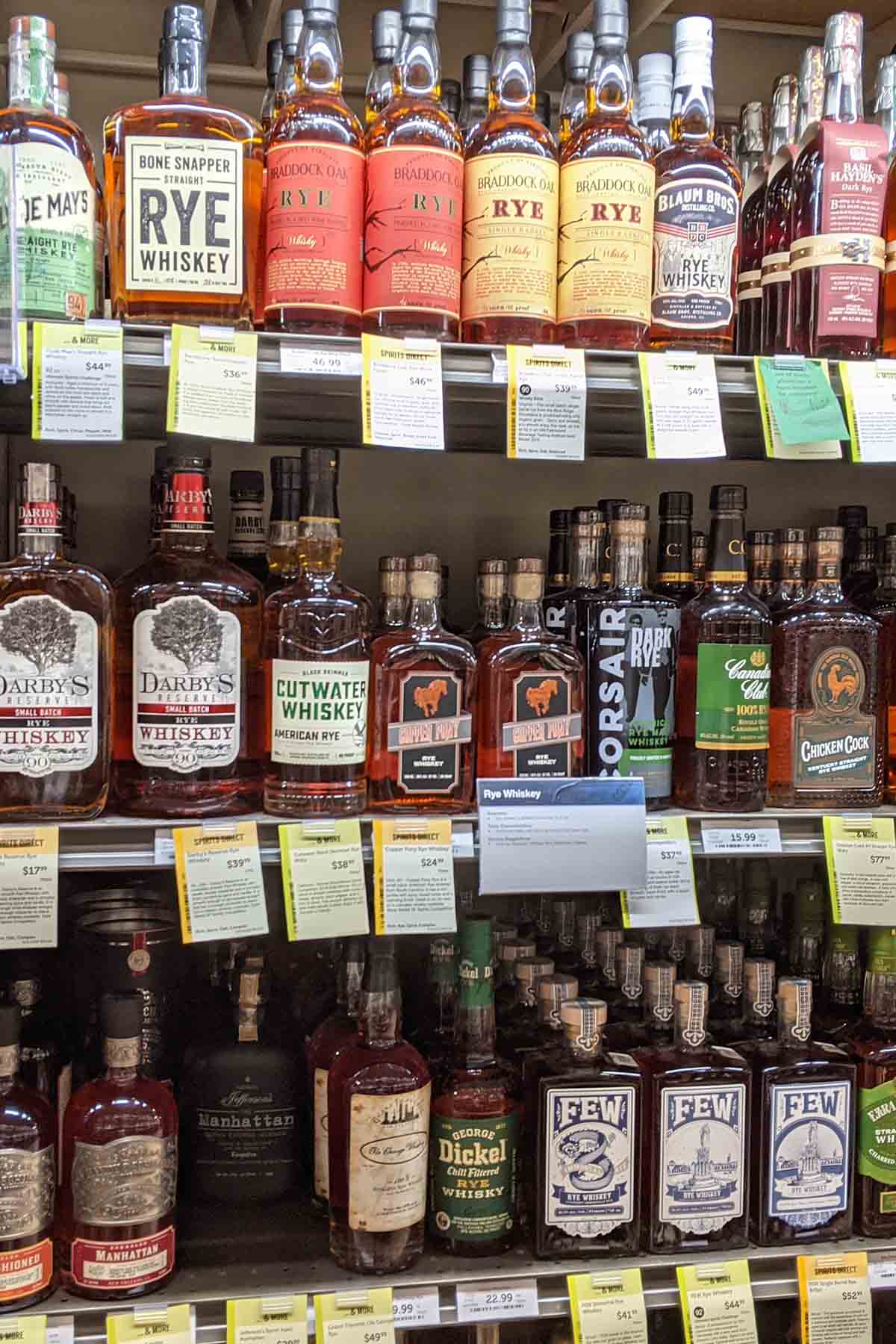 grocery store shelf with various whiskey bottles.