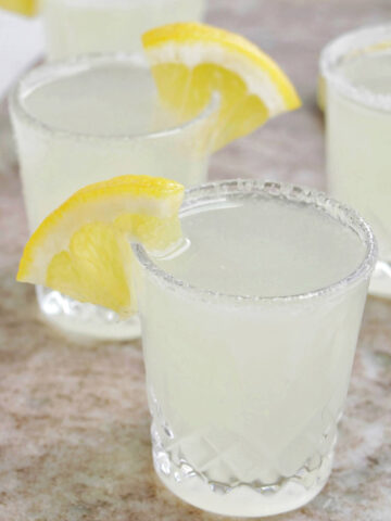lemon drop shots with a lemon wedge garnish.