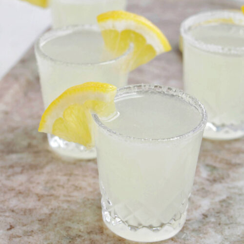 lemon drop shots with a lemon wedge garnish.