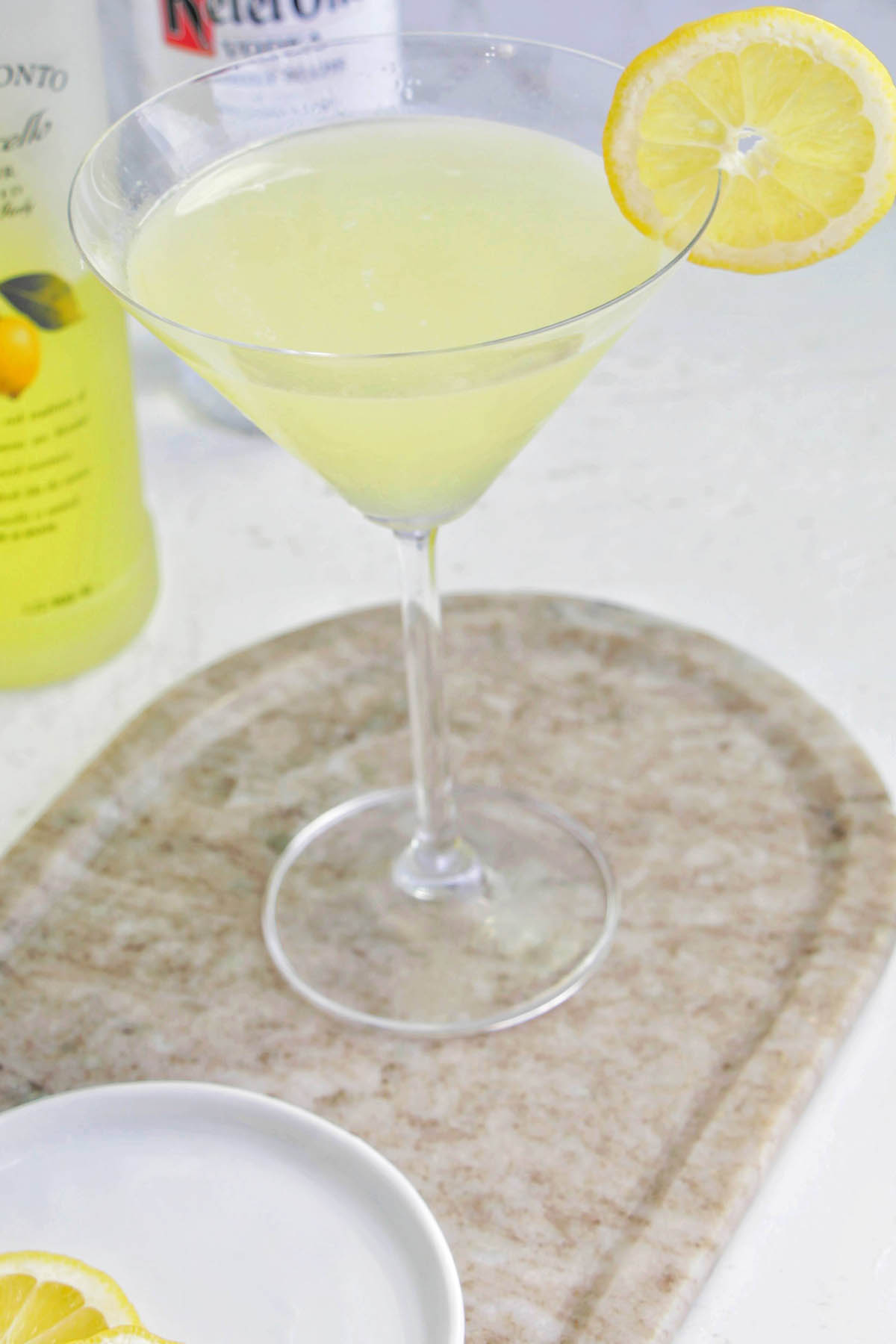 lemon drop martini garnished with a lemon wheel.
