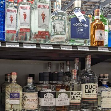 liquor store shelf with bottles of gin.