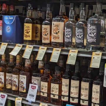 liquor store shelf with bottles of rum.