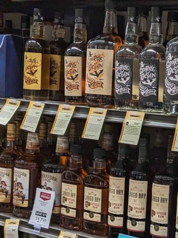 liquor store shelf with bottles of rum.