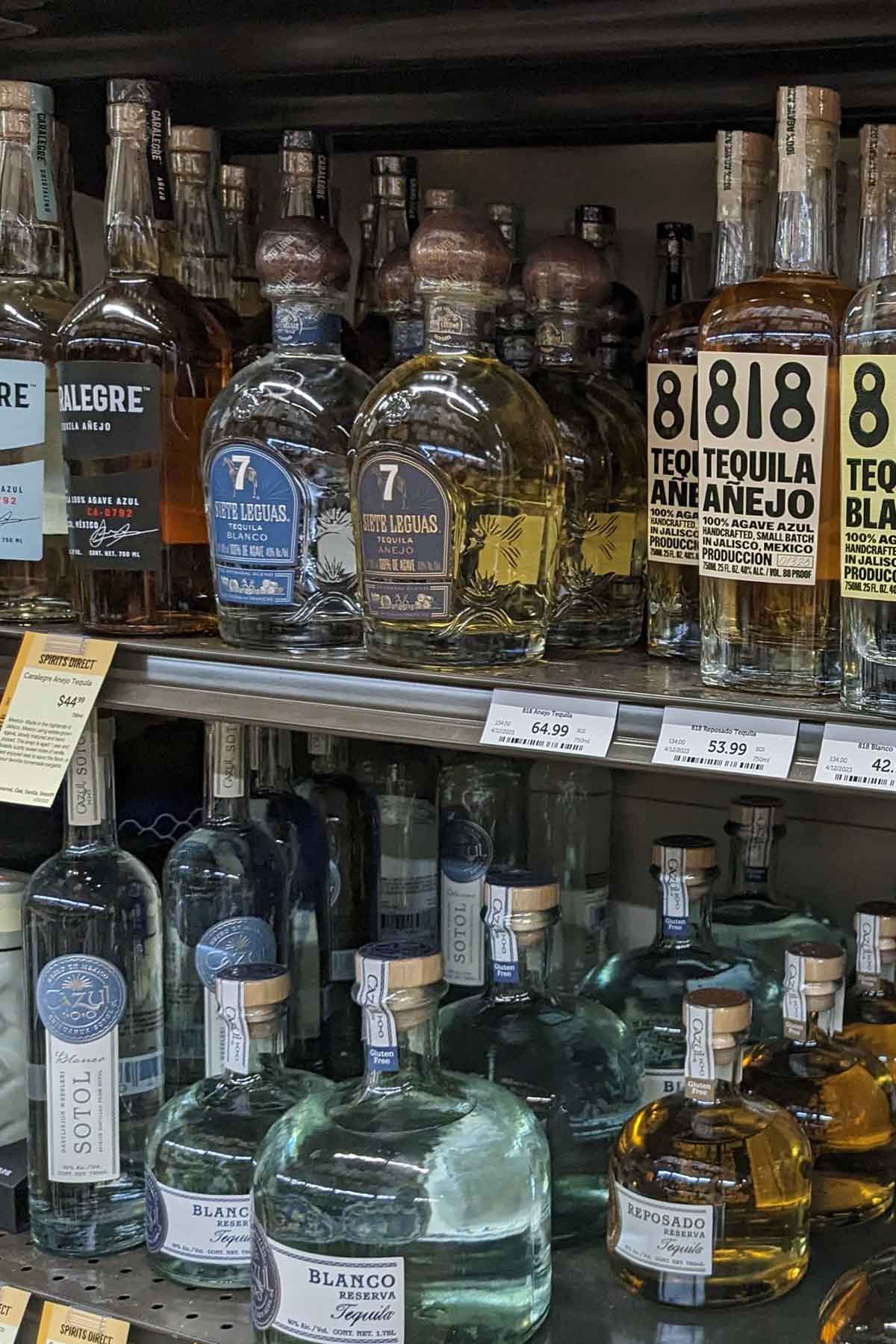 liquor store shelf with bottles of tequila.