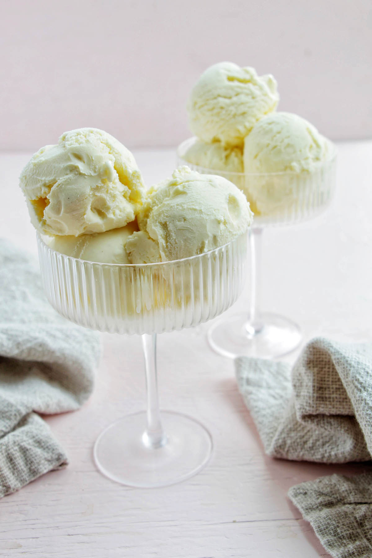 two coupe glasses filled with French vanilla ice cream.