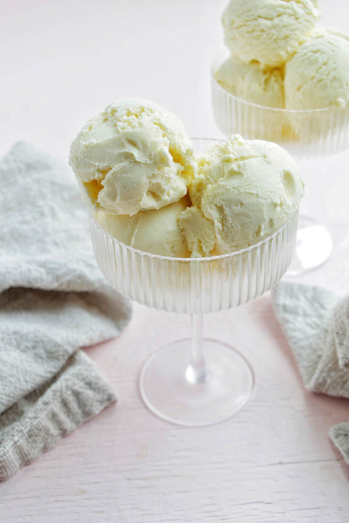 two coupe glasses filled with French vanilla ice cream.