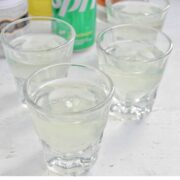 four white tea shots in rocks glasses with text overlay.