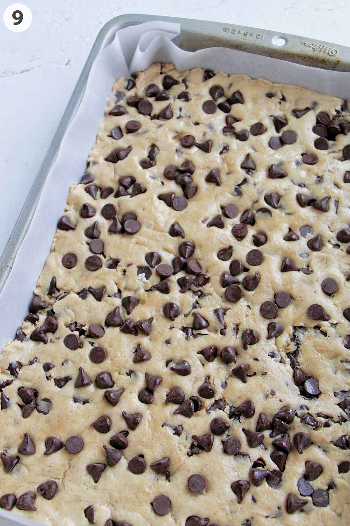 numbered photo showing cookie dough in a 9x13 inch pan.