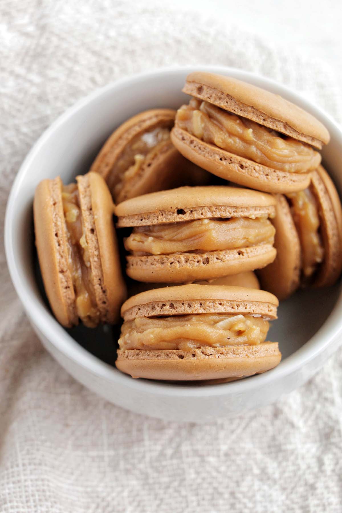 tan macarons filled with coconut caramel.