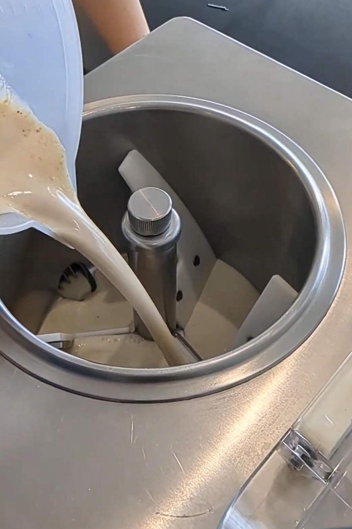 pouring gelato base into a gelato machine.