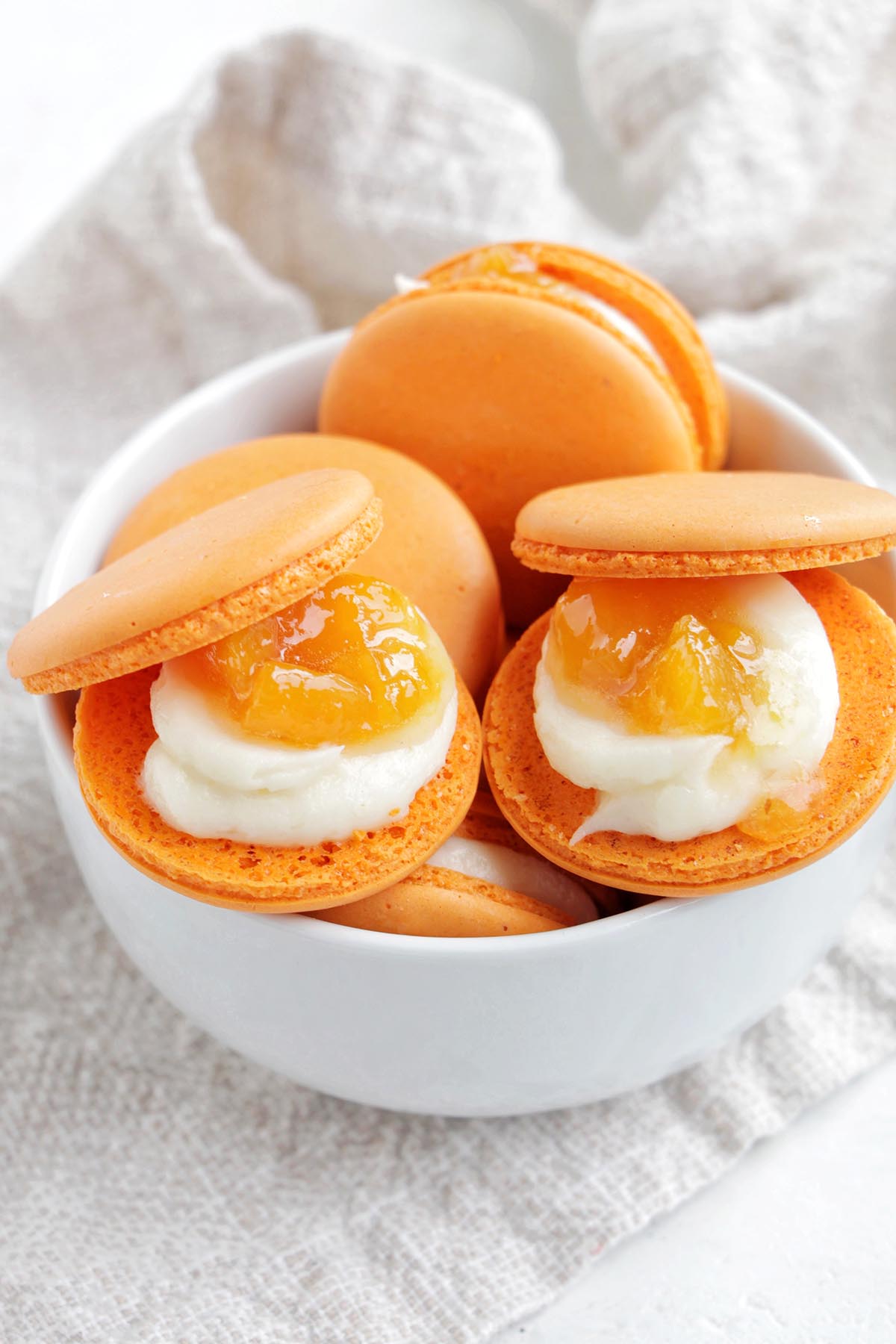 orange macarons filled with peach jam.