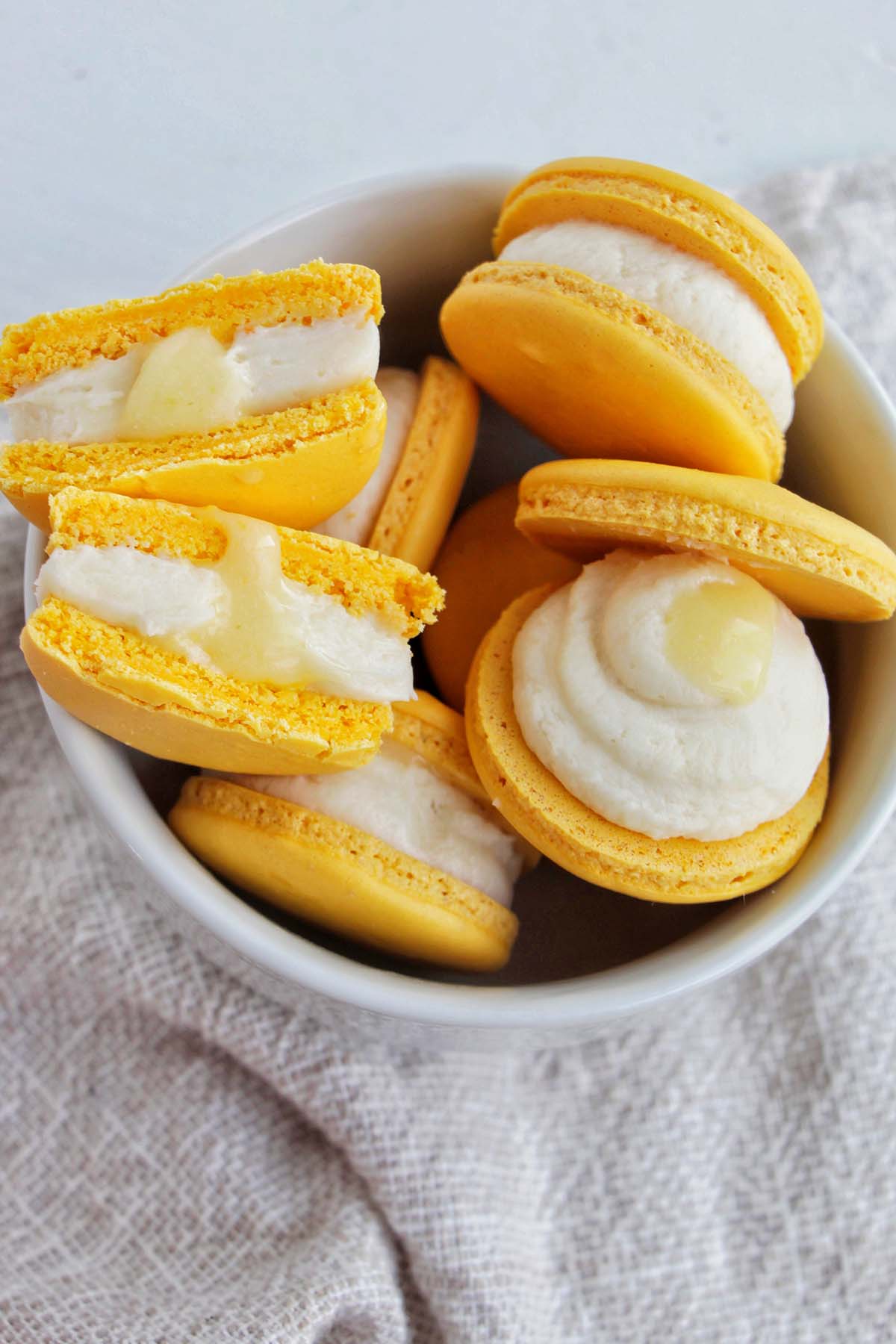yellow macarons filled with buttercream and lemon curd filling.