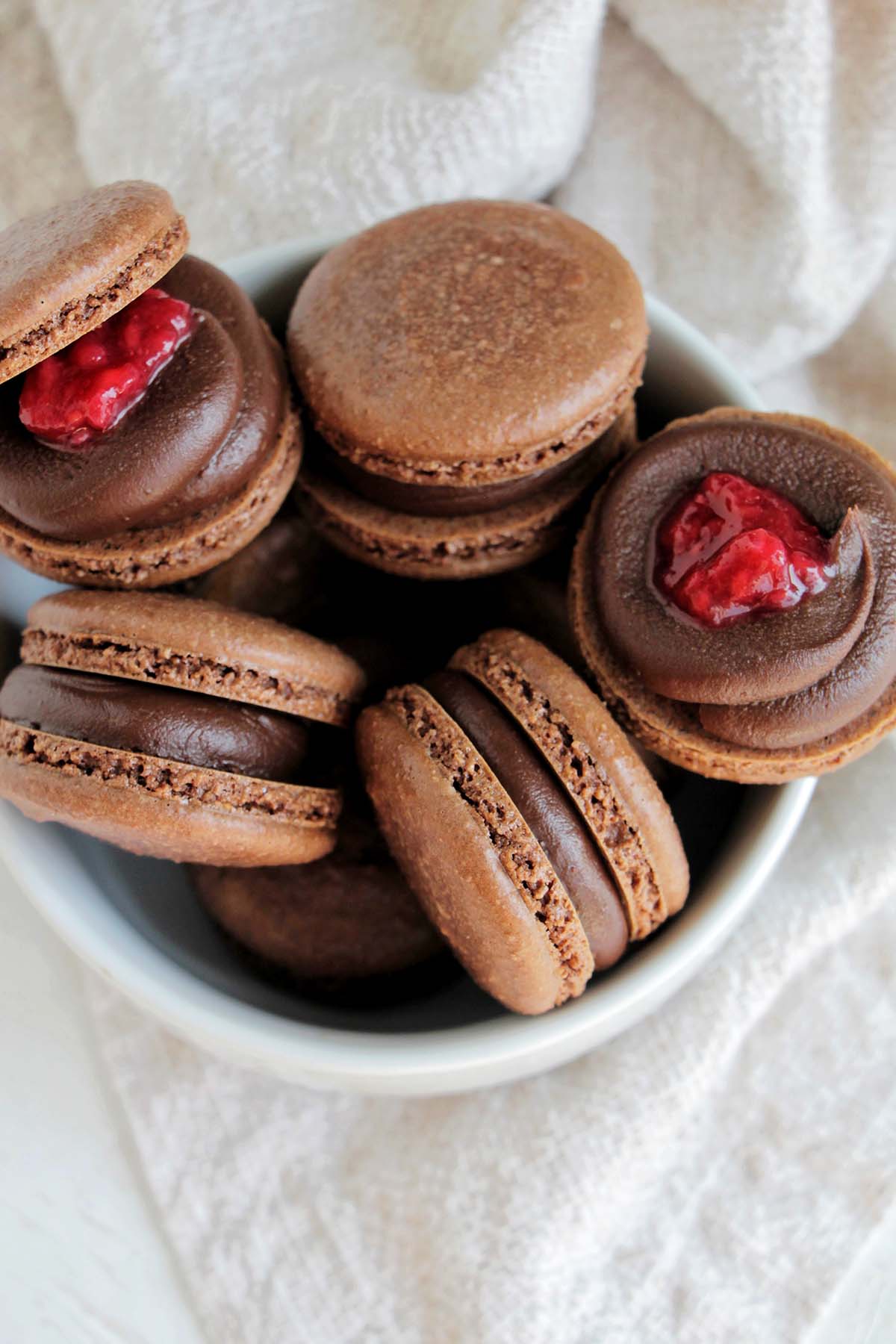 chocolate macarons filled with chocolate ganache and raspberry compote.