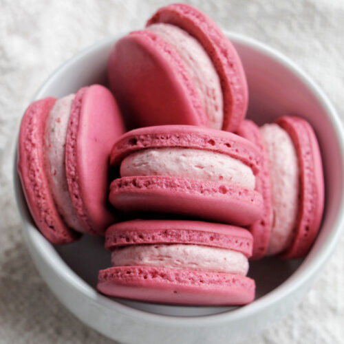 Pink shell macarons with strawberry buttercream filling.