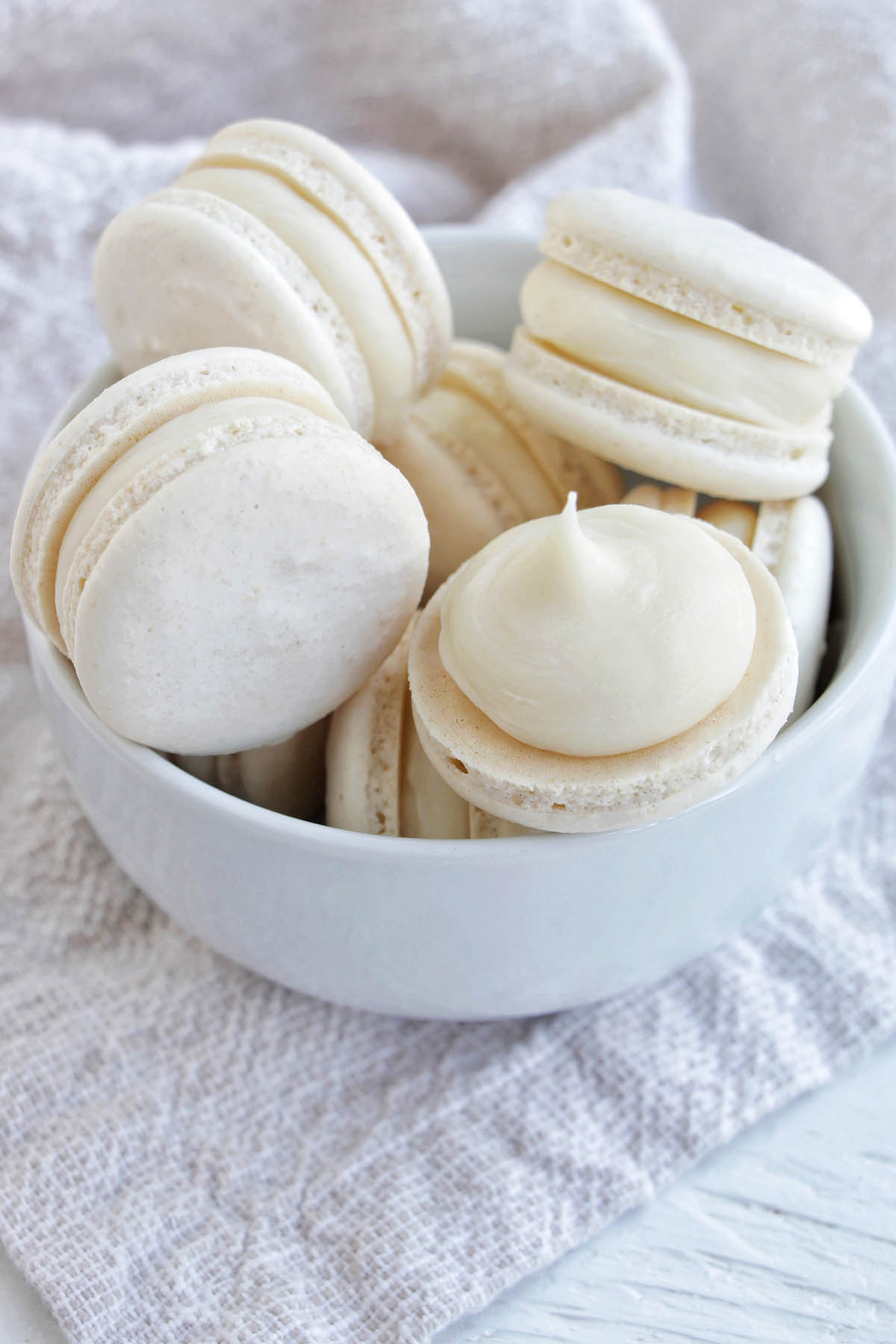 white chocolate ganache macarons in a bowl.