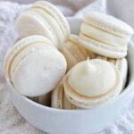 white chocolate ganache macarons in a bowl.