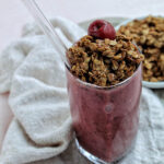 cherry smoothie topped with chocolate granola.