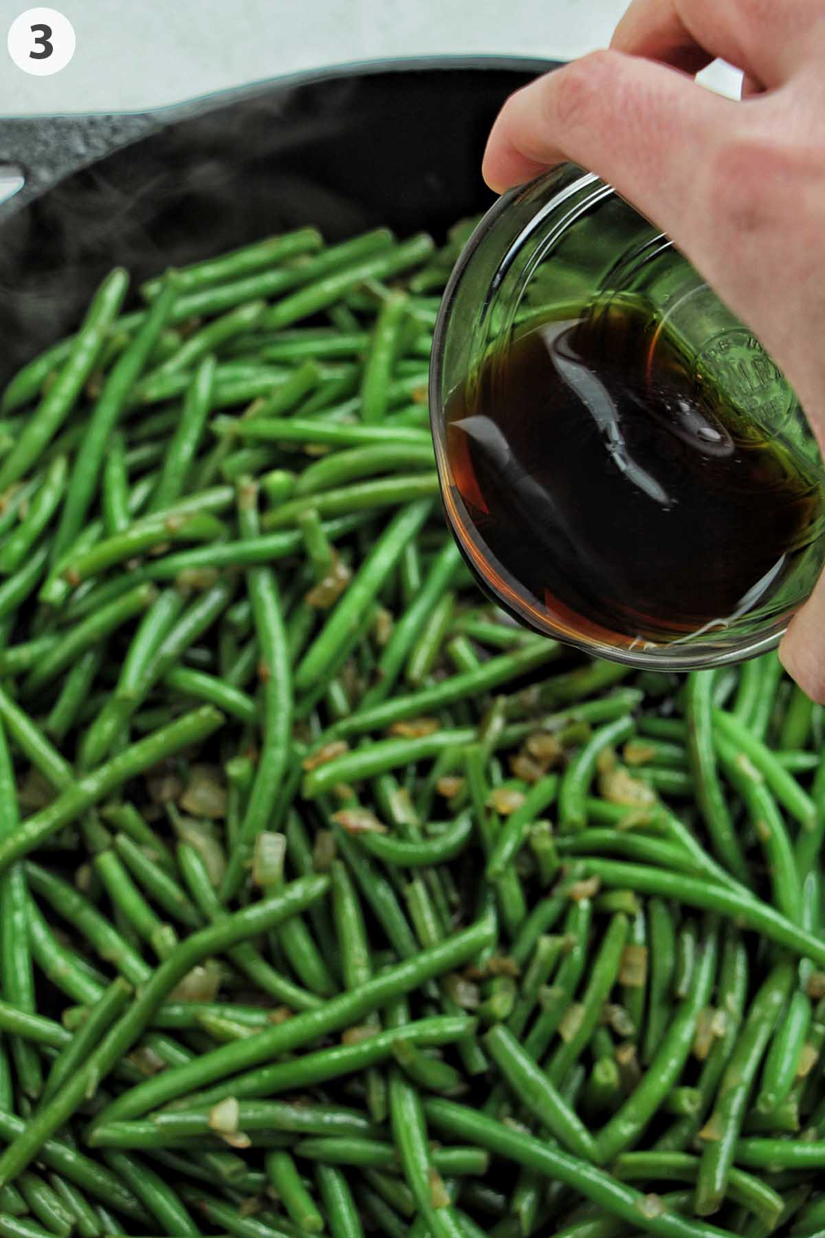 numbered photo dumping soy sauce onto sautéed green beans.