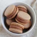 brownie flavored macarons in a bowl.
