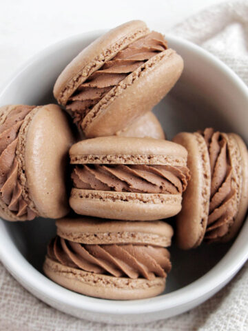 chocolate mint macarons in a bowl.