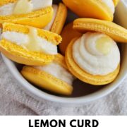 lemon curd macarons in a bowl with text overlay.