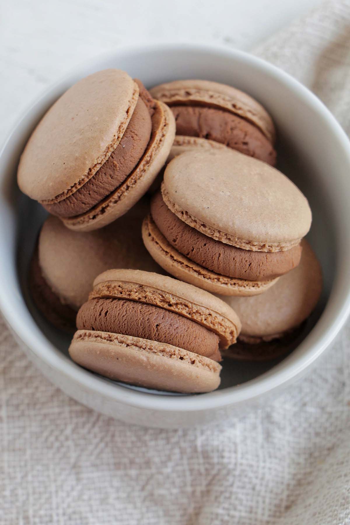 brownie flavored macarons in a bowl.