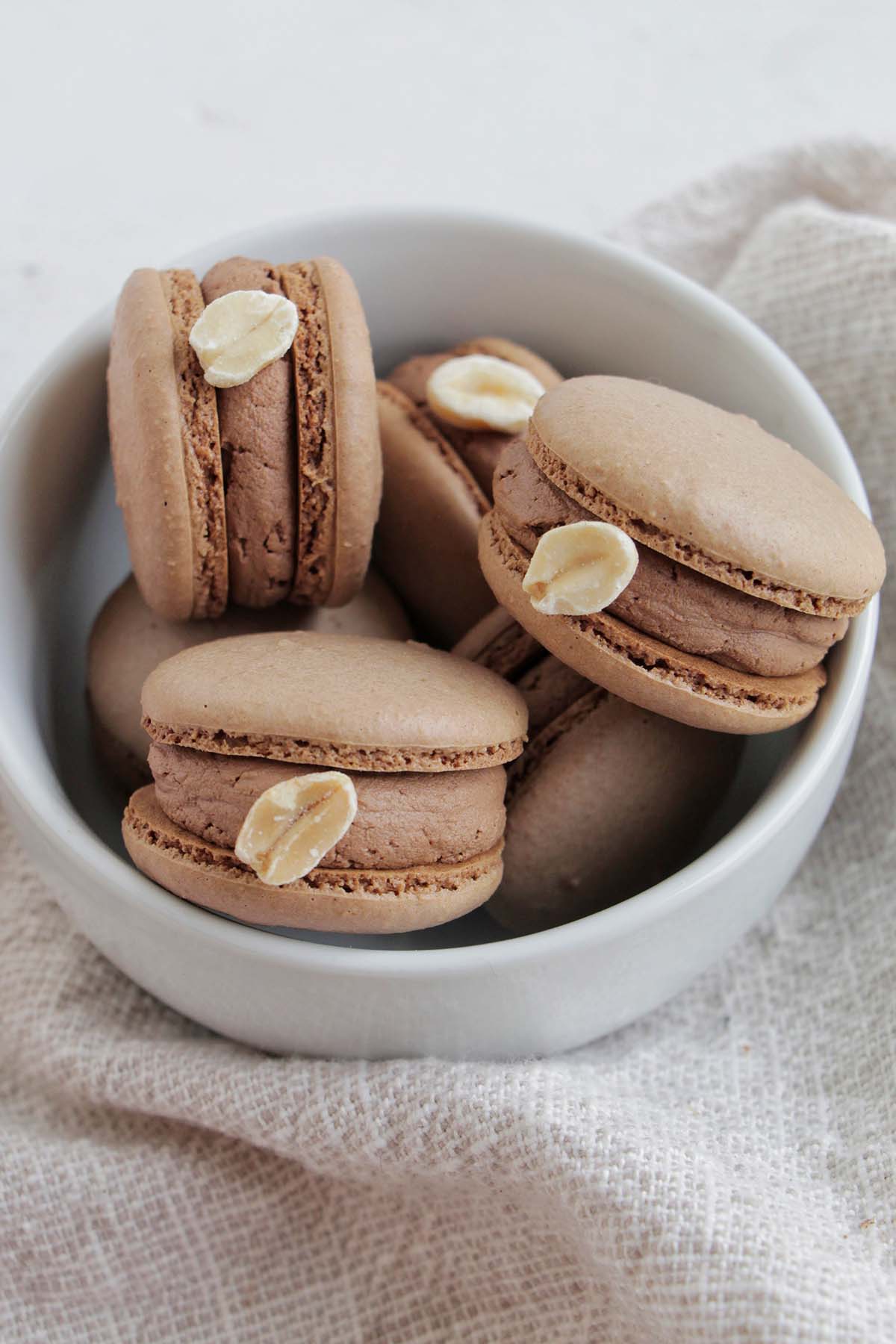 chocolate peanut butter macarons in a bowl.