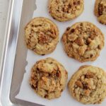 caramelized white chocolate cookies on a sheet tray.